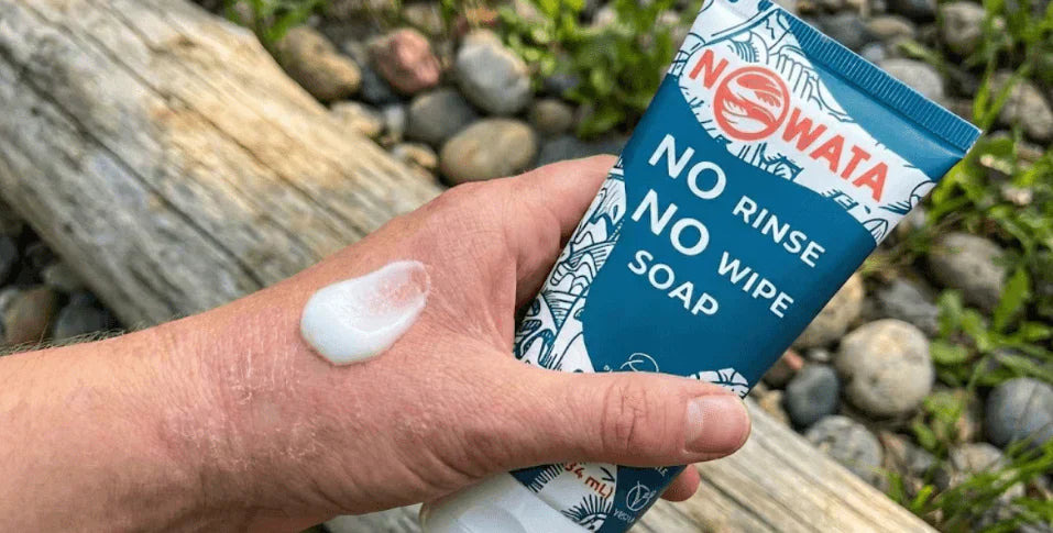 Hand with visible eczema applying Nowata No Rinse No Wipe Soap from a blue tube, illustrative of doctor-made, plant-based relief for sensitive skin.