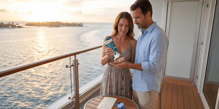 An image of a couple using NOWATA no-rinse soap on a cruise ship balcony before a buffet meal, illustrating cruise norovirus prevention without relying on hand sanitizer dispensers.