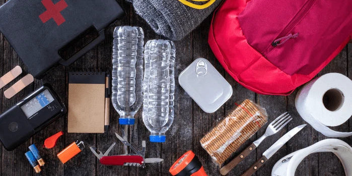 An image of an emergency preparedness kit with flashlights, bottled water, and first-aid supplies.