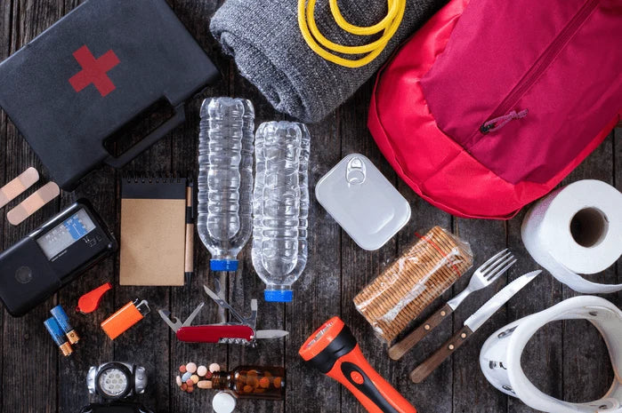 An image of an emergency preparedness kit with flashlights, bottled water, and first-aid supplies.