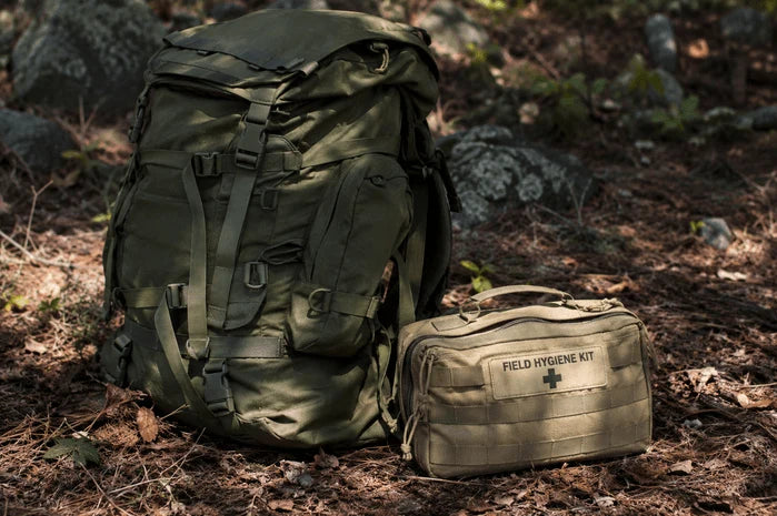 An image of a field hygiene kit laid out beside a rucksack on the ground.