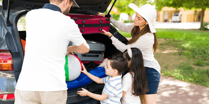 An image of a family packing a car for a road trip.