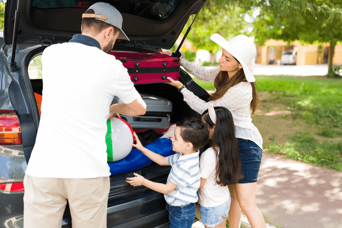 An image of a family packing a car for a road trip.