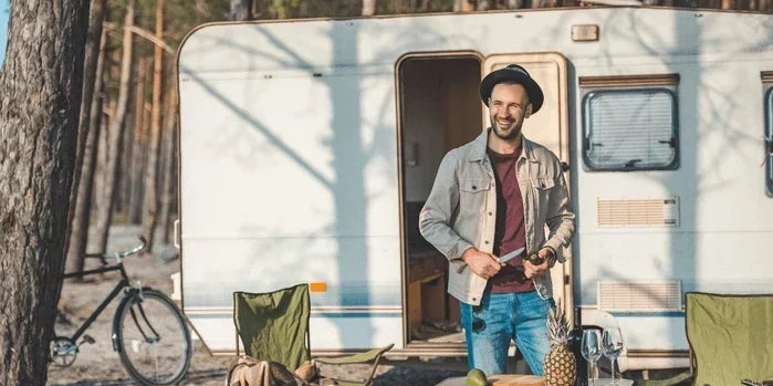 An image of a van-lifer outside a camper.