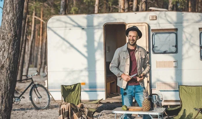 An image of a van-lifer outside a camper.