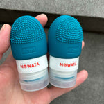 Two refillable silicone bottles with integrated silicone brush in hand
