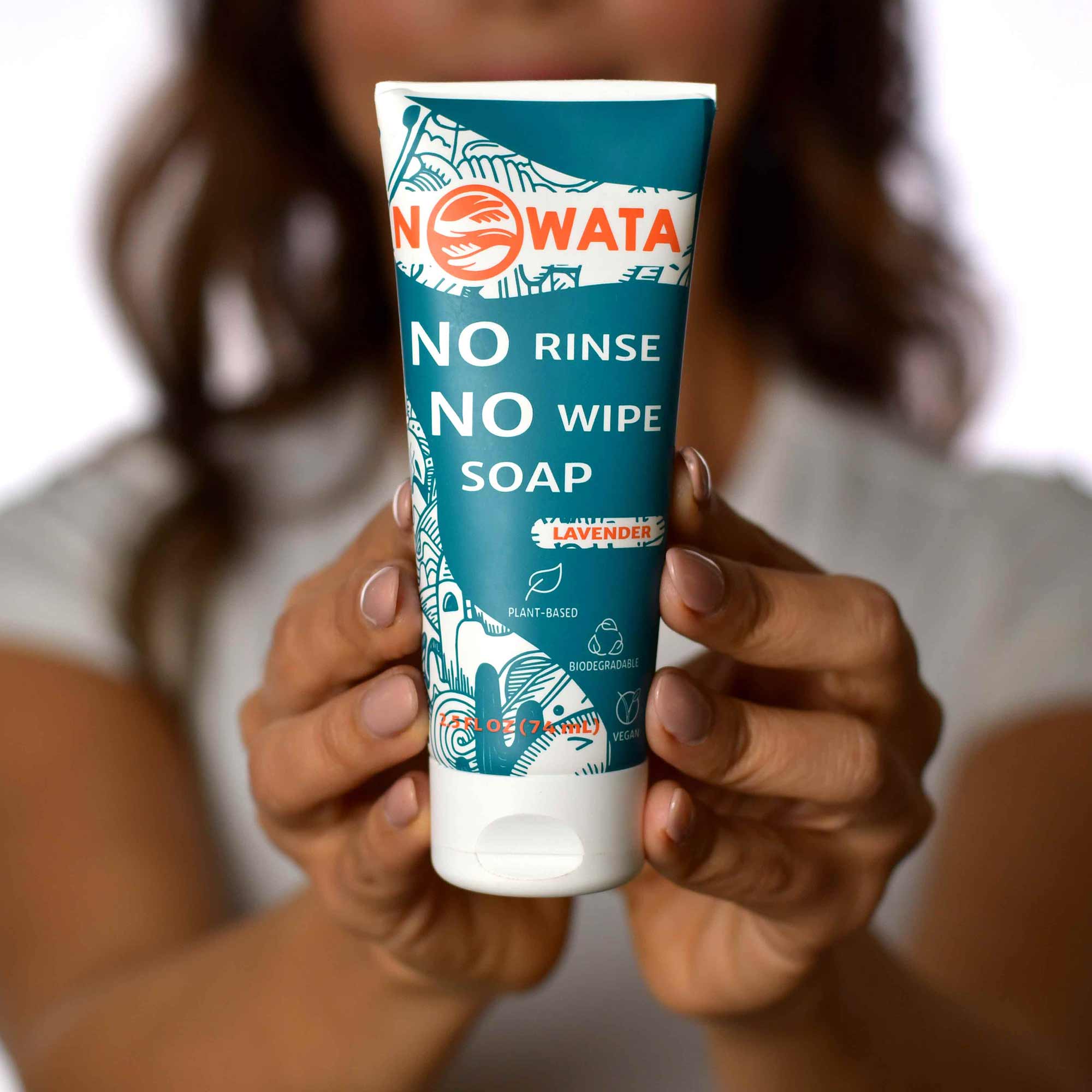 Yalda holding bottle of no rinse no wipe soap NOWATA